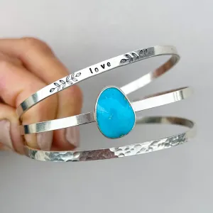 Blue turquoise "love" cuff set in silver